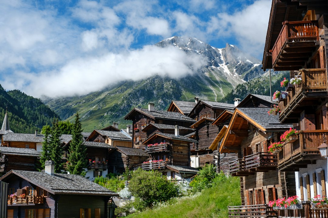 Wooden condo buildings in a mountain resort village, illustrating condo insurance for co-owners in Quebec